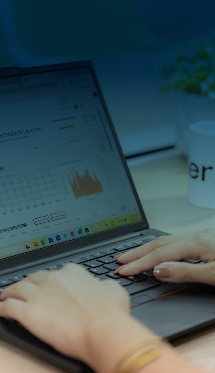 Employee working on laptop with analytics dashboard
