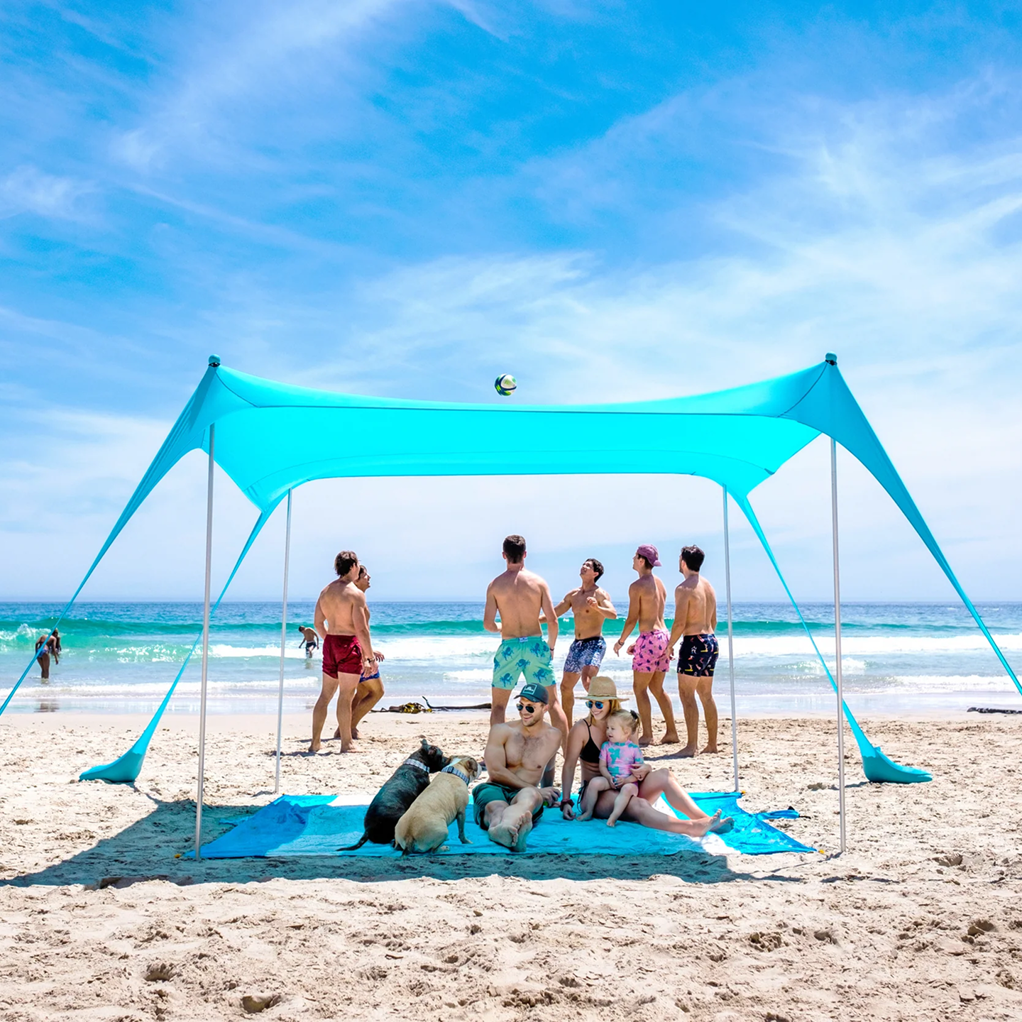 Sun Ninja beach tent with people enjoying beach activities